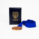 The St Andrews 600 85mm Bronze Antique Sports Medal Reverse with blue ribbon and a gold foil embossed presentation case