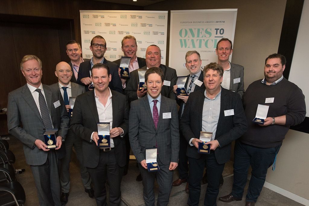 Group of people holidng their European Business Awards Medals