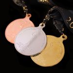 Close up of Gold Silver and Bronze Fly Casting World Championships 2018 Sports Pendant lay flat